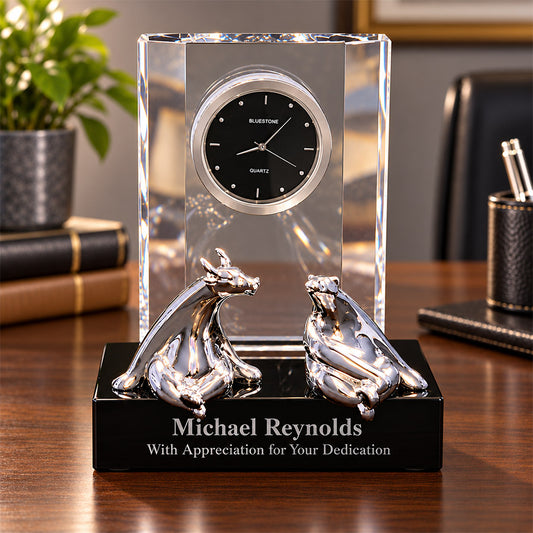 Personalized crystal desk clock featuring silver bull and bear figurines on a black base, engraved with Michael Reynolds name and With Appreciation for Your Dedication message, displayed in an executive office setting -- lxi-context:retirement