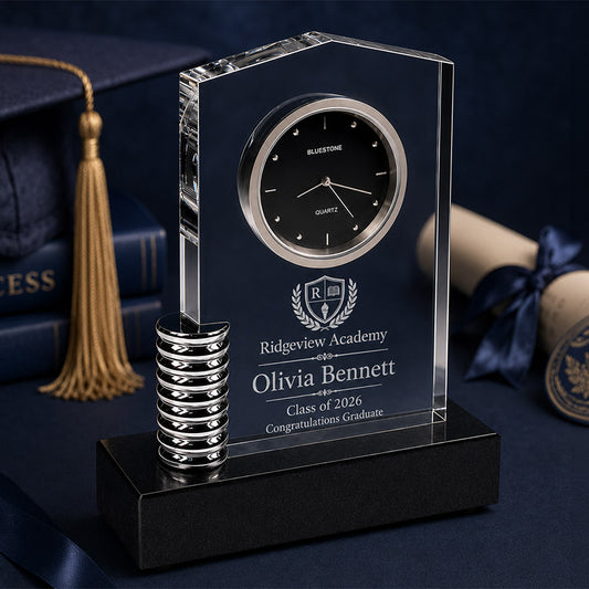 Personalized crystal desk clock with metal accent, black base, Ridgeview Academy crest, Olivia Bennett name, and Class of 2026 message -- lxi-context:graduation