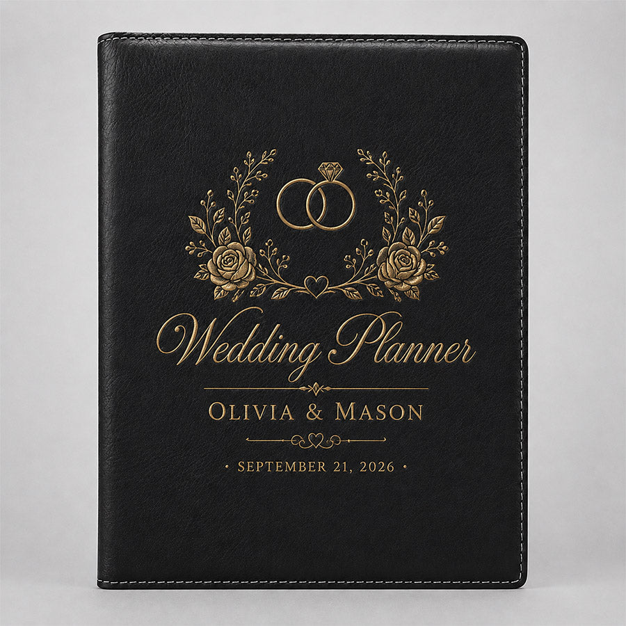 Personalized black leatherette portfolio with gold wedding planner design, floral accents, couple names, and wedding date -- lxi-context:wedding