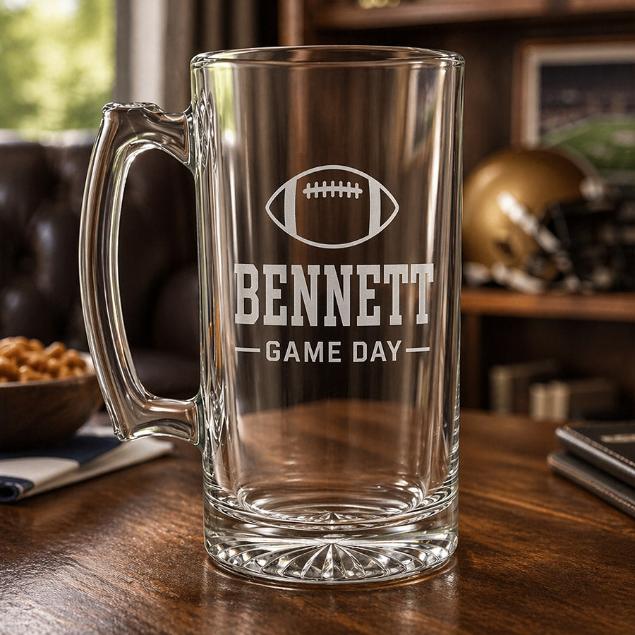 Personalized clear glass beer mug with engraved football, Bennett name, and Game Day design in a sports-themed display -- lxi-context:for-coach