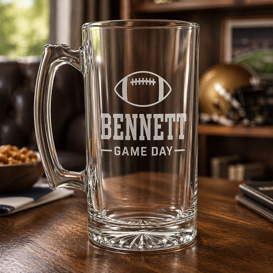 Personalized clear glass beer mug with engraved football, Bennett name, and Game Day design in a sports-themed display -- lxi-context:for-coach