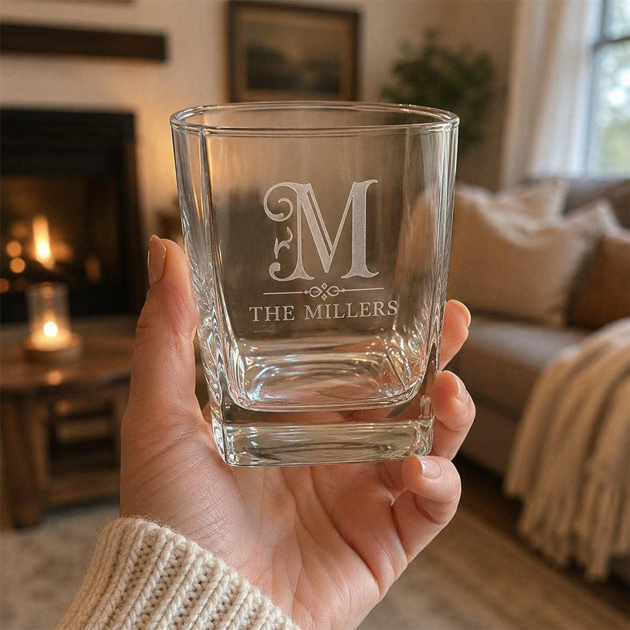 Personalized rocks glass with engraved Miller family monogram, held in a cozy housewarming display -- lxi-context:house-warming