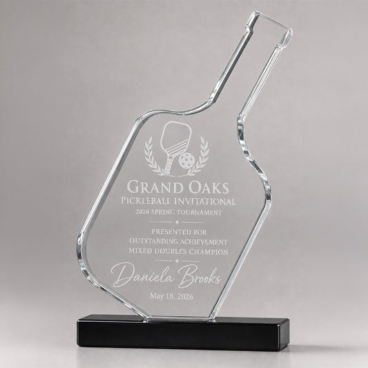 Personalized crystal pickleball award with engraved tournament title, mixed doubles champion message, recipient name, and black base
