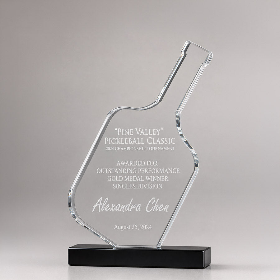 Personalized crystal pickleball award with engraved tournament title, gold medal winner message, recipient name, and black base