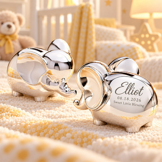Personalized silver elephant keepsake pair with engraved Elliot name, birth date, and Sweet Little Blessing message in a soft yellow nursery setting -- lxi-context:for-baby -- lxi-context:new-baby