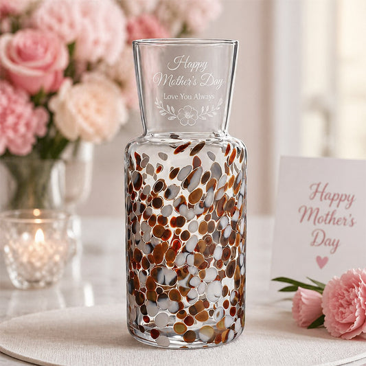 Engraved decorative glass vase with Happy Mother’s Day message, floral accent design, and soft pink display setting -- lxi-context:mothers-day